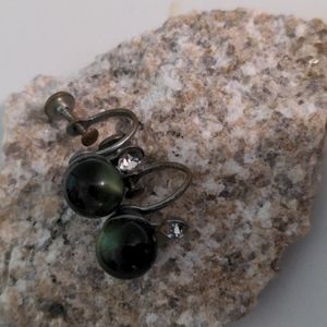Vintage green screw on earrings in a gold tone setting